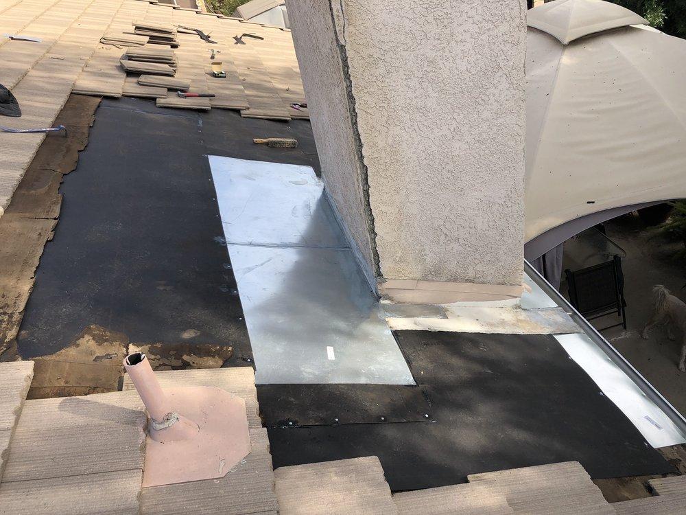 Chimney leak repair with rebuilt flashing