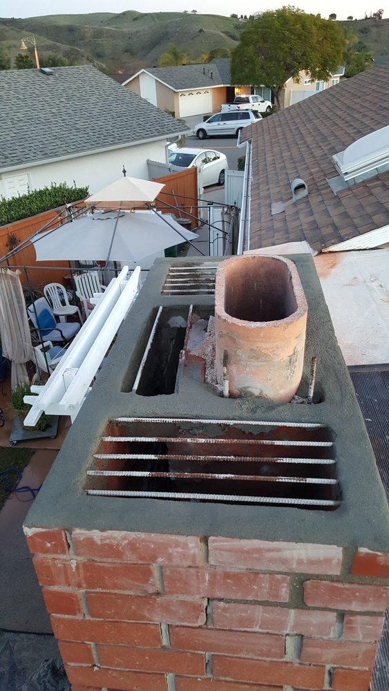 Chimney top with exposed rebar grid, prepped for a new concrete crown pour
