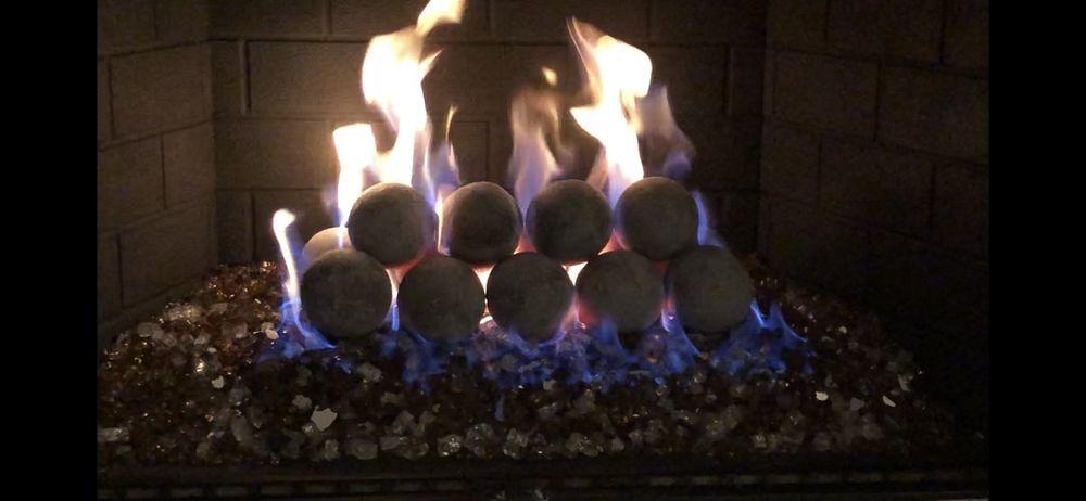 Gas fireplace burning cleanly with ceramic logs after inspection