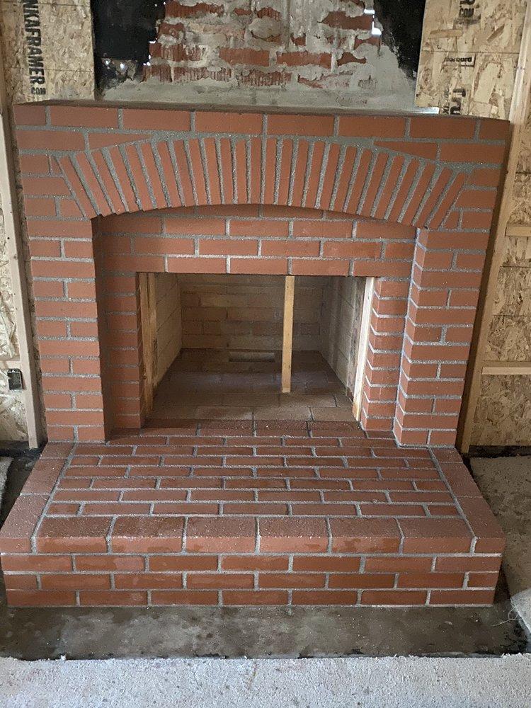 Finished brick firebox with an arched surround after a refacing